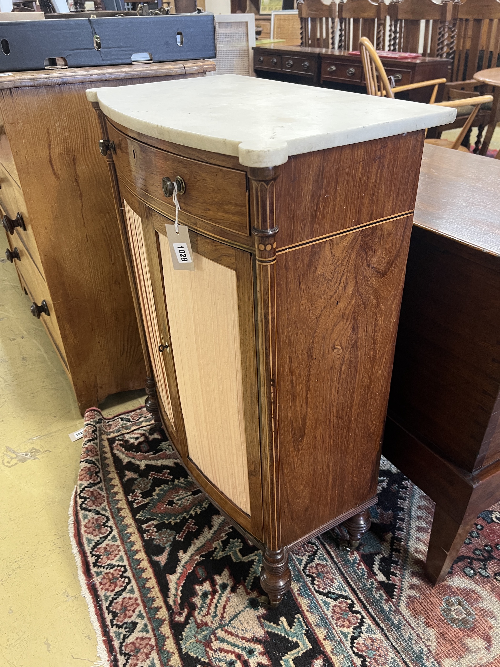 A George III Sheraton style faded rosewood bow front marble top side cabinet, width 65cm, depth 35cm, height 89cm